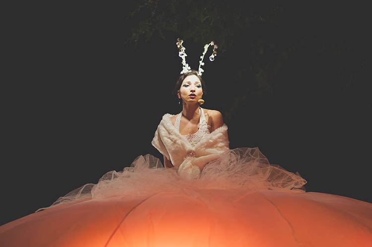 lady dressed in white welcomed the guests and newlyweds