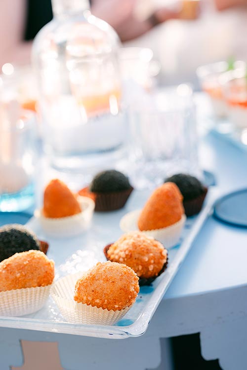 Tray of Sicilian arancini and savoury finger foods served during the romantic wedding dinner in Taormina, Sicily.