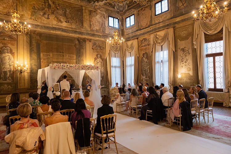 Interfaith wedding ceremony inside a historic frescoed palace in Venice