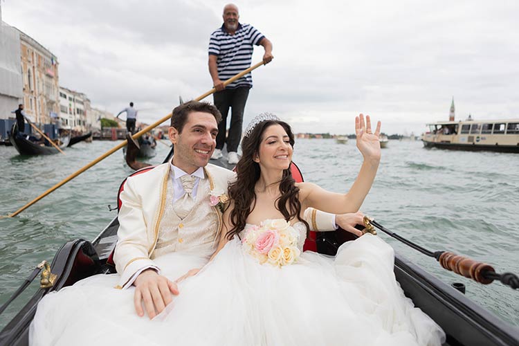 Bride and groom enjoying a gondola ride through the canals of Venice