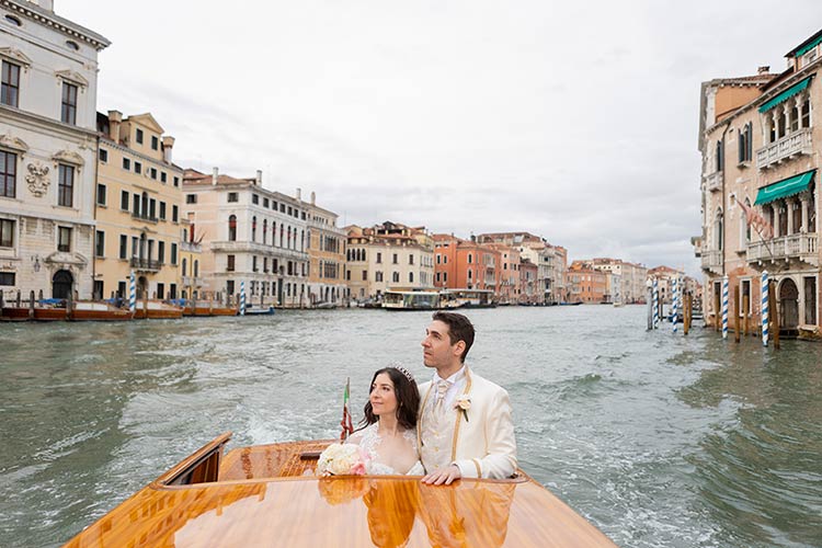 Bride and groom enjoying a boat tour along the Grand Canal