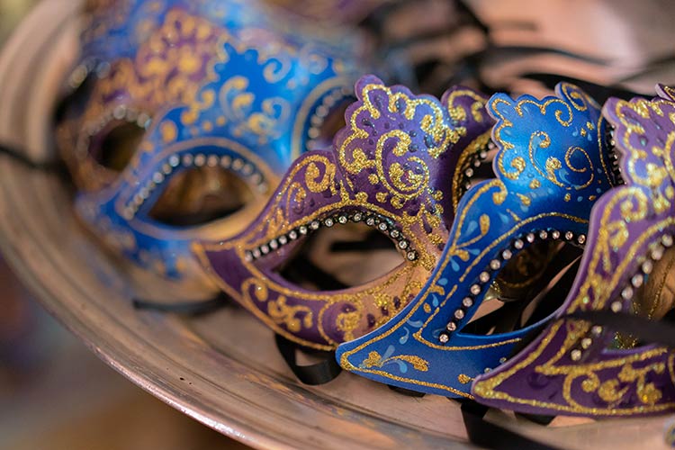 Close-up of handcrafted Venetian masks created by a local artisan for the wedding reception.
