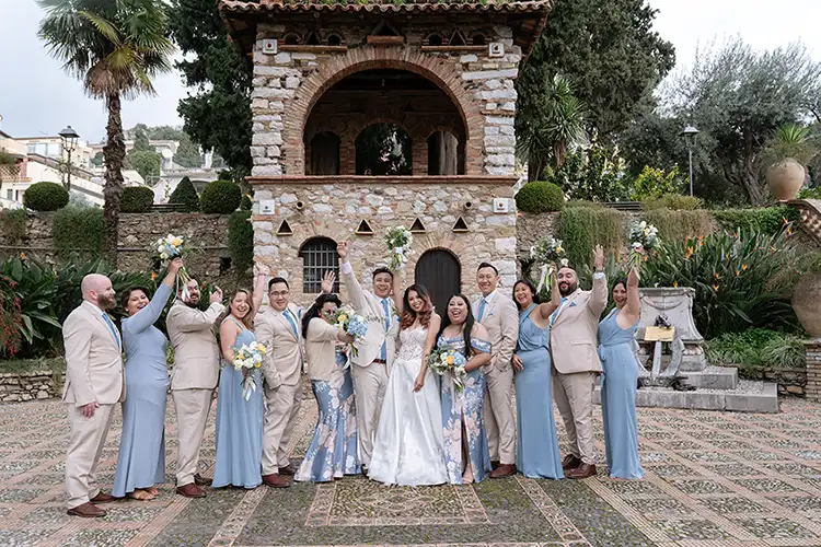 Joyful winter wedding in Taormina Sicily with bride and groom celebrating with their guests