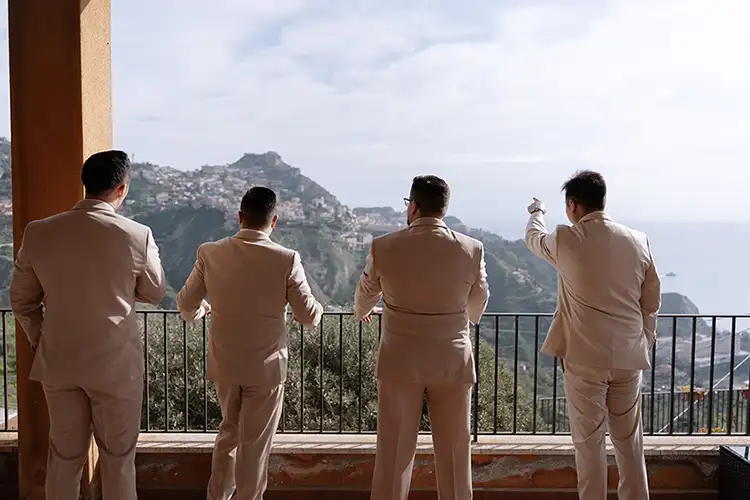 Groomsmen enjoying panoramic views of Taormina during winter wedding preparations