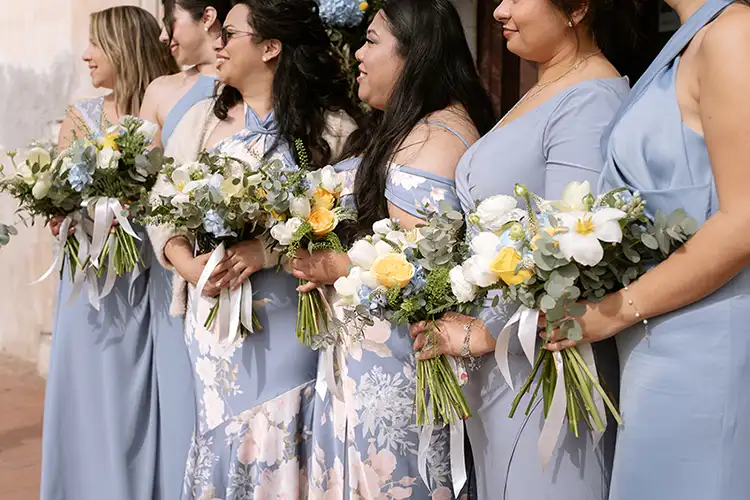 Bridesmaids holding white and yellow bouquets during a Taormina wedding