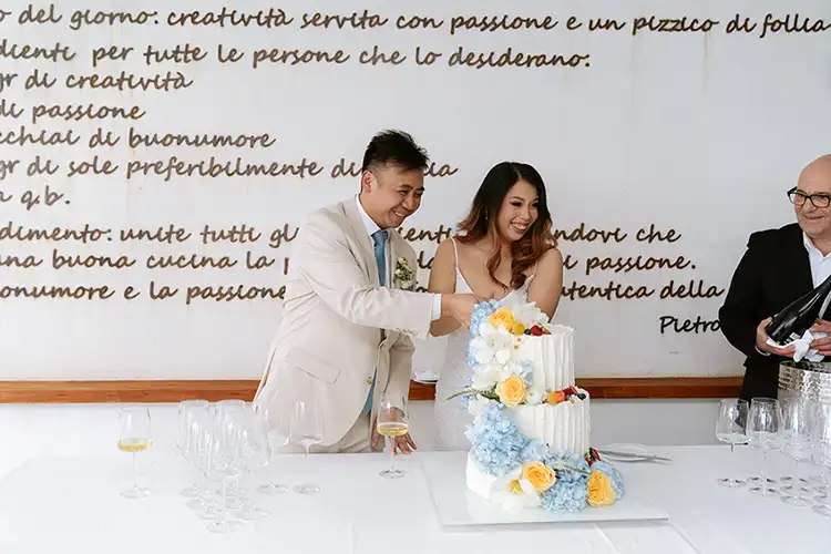 Wedding cake cutting during an intimate winter wedding celebration in Sicily