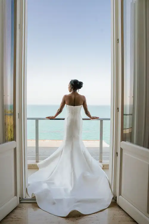 Bride in elegant gown overlooking the Adriatic Sea from Villa Estea balcony in Abruzzo