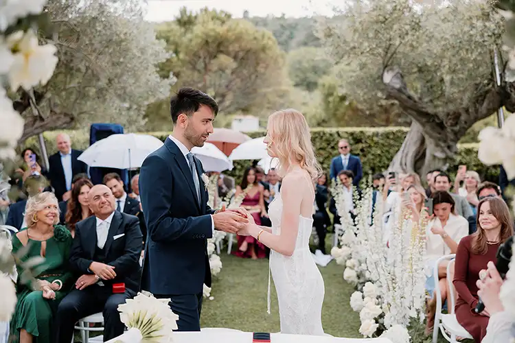 Bride and groom exchanging rings during an outdoor wedding ceremony in Abruzzo overlooking the Adriatic Sea