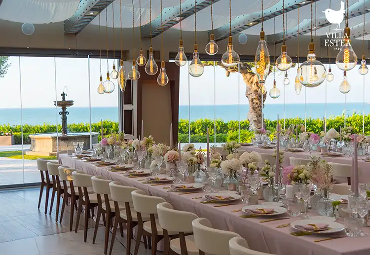 Refined white floral wedding décor for a seaside reception in Italy