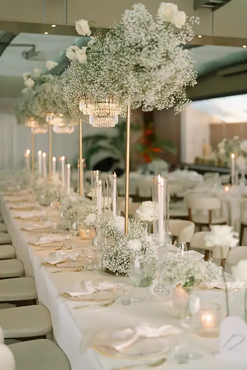 Refined white floral wedding décor for a seaside reception in Italy