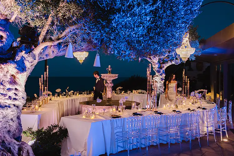 Elegant seaside wedding reception setup with chandeliers and candlelight in Abruzzo