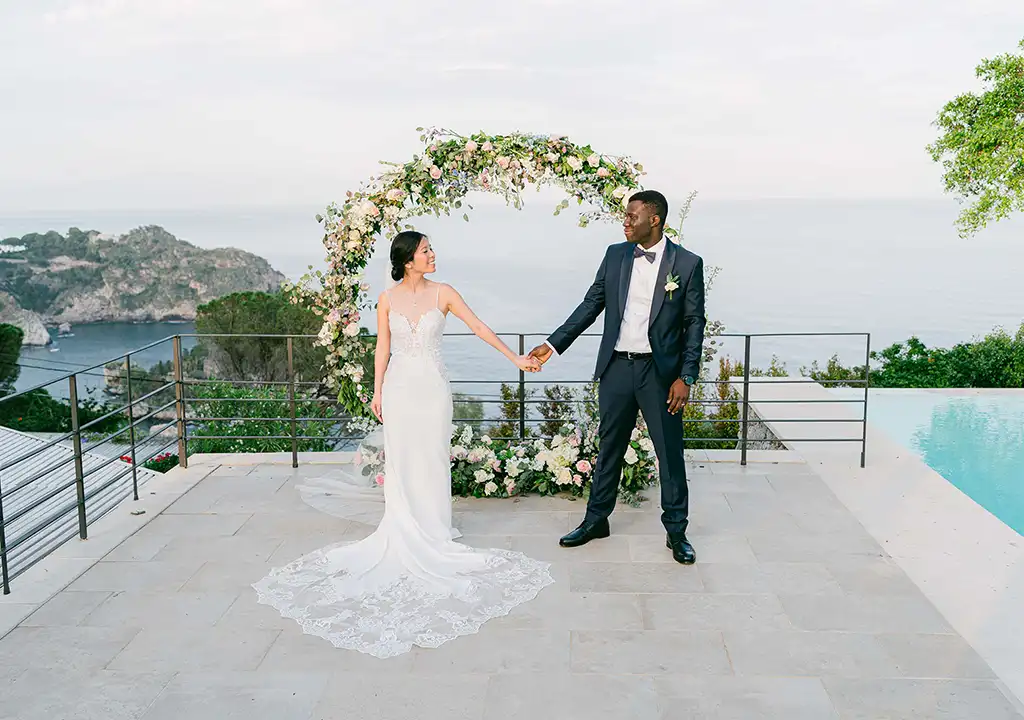 wedding-in-taormina_05 Sea-view wedding ceremony in Taormina with floral arch and Isola Bella backdrop