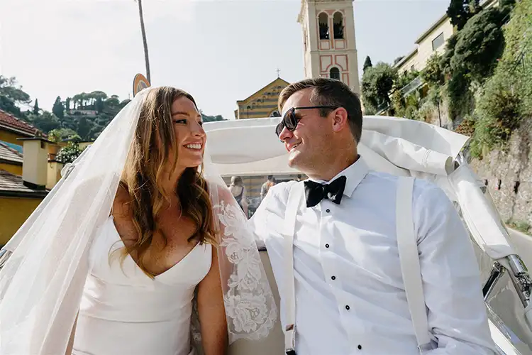Bride and groom riding through Portofino in vintage Italian Ape