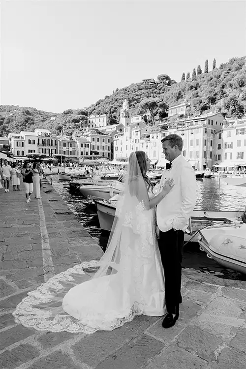 Bride and groom walking along the Portofino harbour