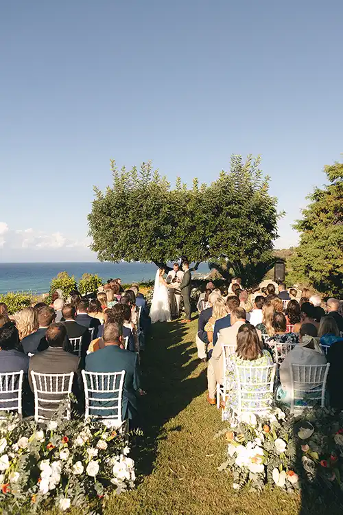Wedding ceremony setting beneath the iconic pine tree at Villa Paola
