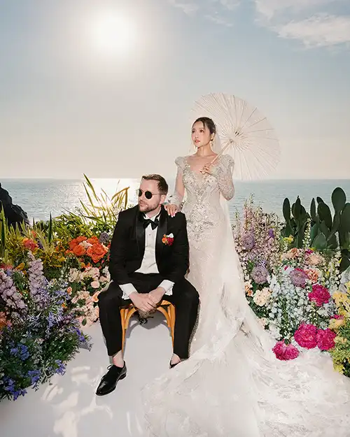 Bride and groom at a destination wedding in Capri surrounded by colourful Mediterranean flowers