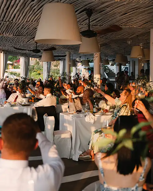 Guests raising a toast during a wedding reception in Capri
