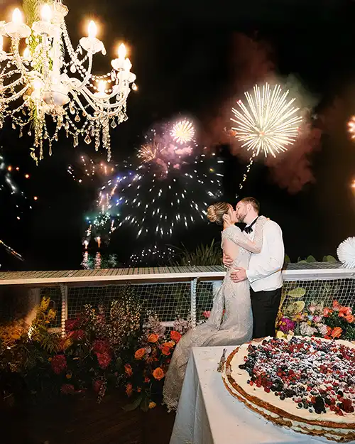 Bride and groom kissing during a fireworks display in Capri