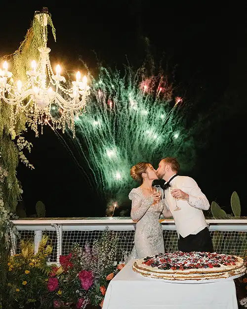 Bride and groom cutting their wedding cake in Capri