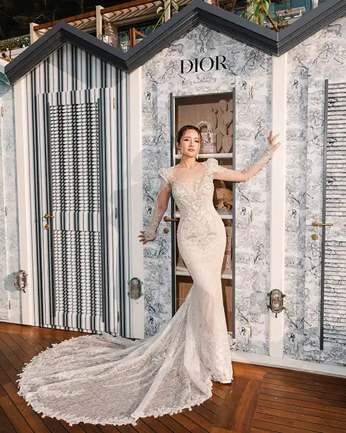 Bride posing in front of a Dior-inspired installation during a wedding in Capri