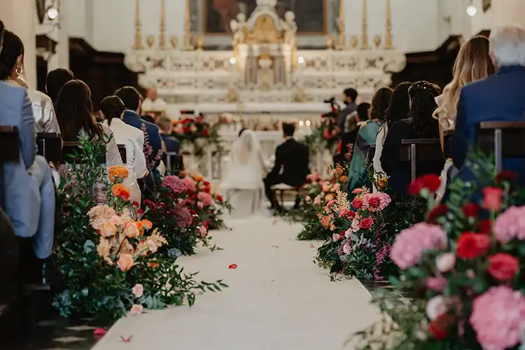 Bride and groom exchanging vows during their Roman Catholic wedding ceremony in Garlenda