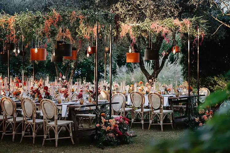 Outdoor wedding reception tables surrounded by Mediterranean greenery in the heart of Liguria
